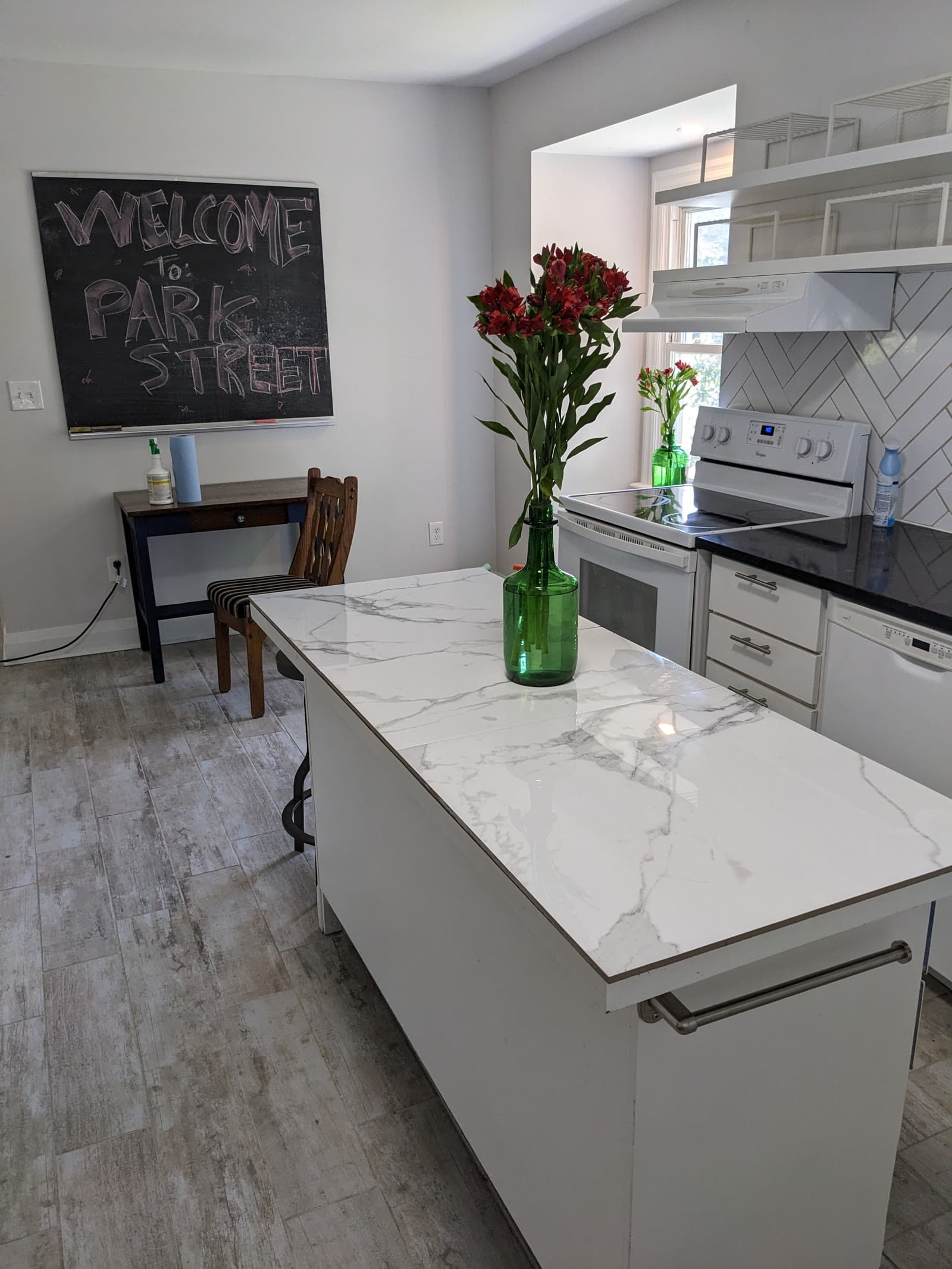 Bright Unit 1 kitchen with white cabinetry and a central island